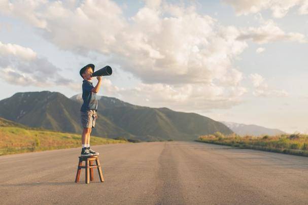 Child with megaphone making an announcement