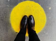 Feet standing on a yellow spot