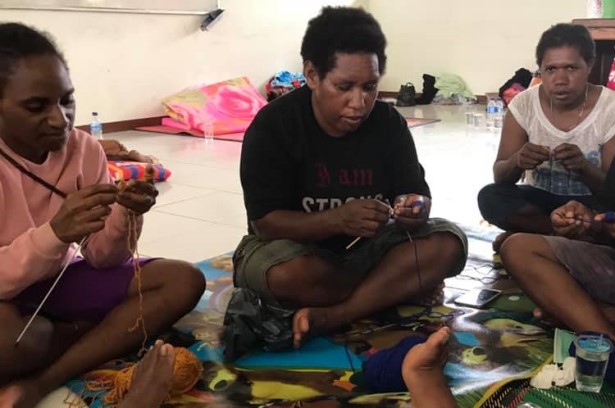 Women learning to knit