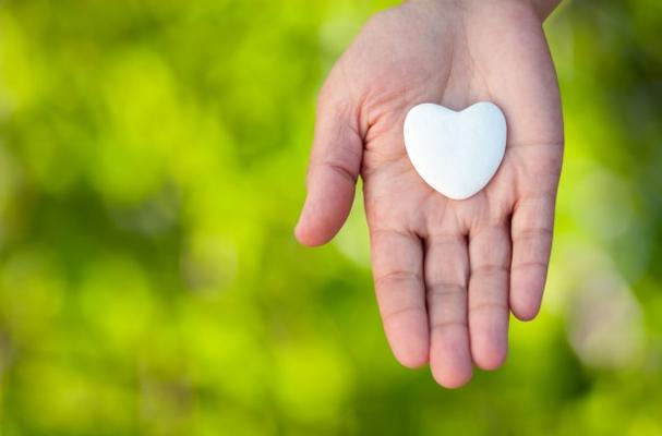 Heart pebble in hand