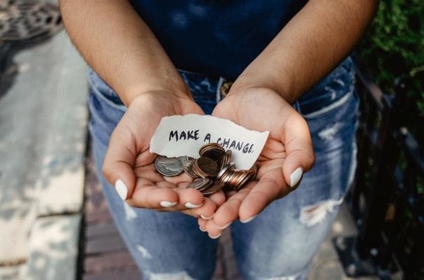 Open hands with coins for fundraising